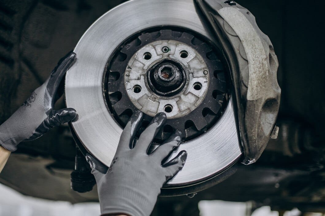 mechanic-changing-brake-discs-car-service_1303-26910