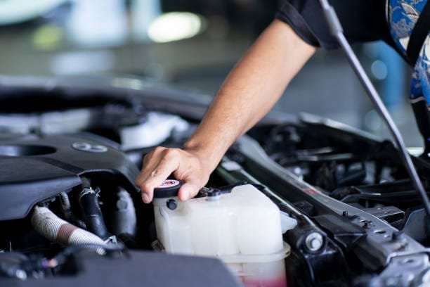 Mechanic Hand checking the coolant water or liquid